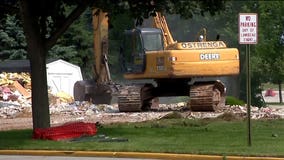 Crews begin razing three homes near Lambeau Field for redevelopment surrounding stadium