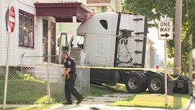 Semi driver arrested for OWI after crashing into home while attempting to make turn