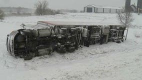 Semi rolls down an embankment during snowfall in Dodge County