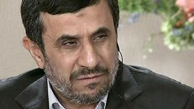 Ahmadinejad jokes he'd volunteer to go to space