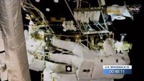 Spacewalking astronauts add parking spot to space station