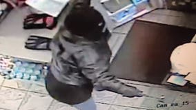 Caught on camera: Woman armed with hammer or hatchet robs gas station