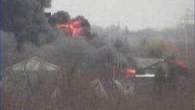 Neighbors hear "loud booms" from auto salvage fire; some evacuated