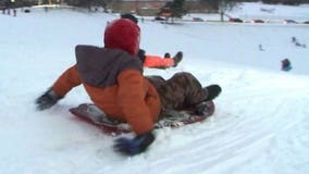 Drivers take it easy as kids have fun in the fresh snow in Racine