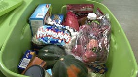 Hunger Task Force volunteers stuff bins with Thanksgiving food for the needy