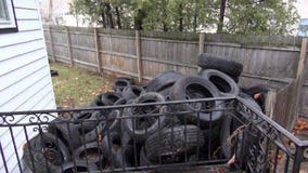 Racine couple returns from vacation to old tires dumped in yard