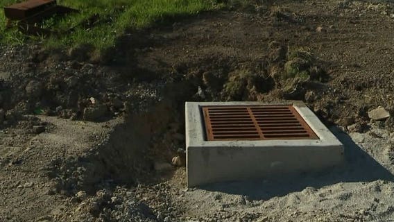 "I couldn't find her:" Woman rescued after falling into open sewer access box under construction