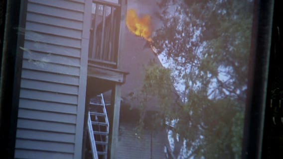 "Hanging their children out the side:" Neighbors come to rescue of family trapped in burning home