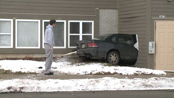 "Somebody got really lucky:" Car ends up stuck in building after collision with SUV