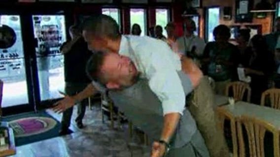 President Obama gets a bear hug from a business owner