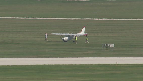 2-seat private plane runs into grass at end of runway at Mitchell International Airport