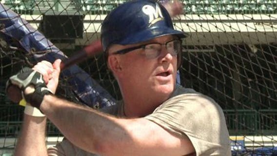 Brewers season ticket holder Ted Perry takes a crack at the bat