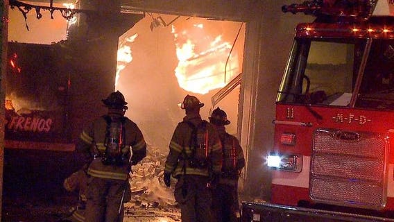 Firefighters battle 2-alarm fire in auto shop on Milwaukee's south side
