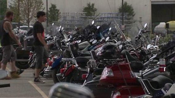 Riders check out other bikes in parking lots