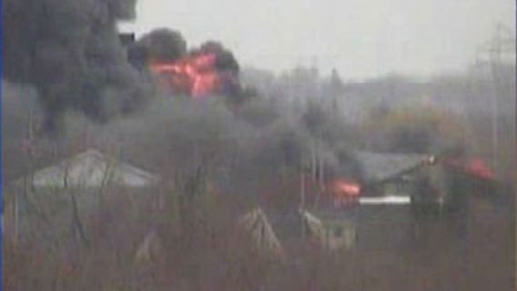 Neighbors hear "loud booms" from auto salvage fire; some evacuated