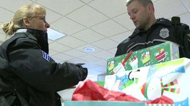 Milwaukee police officers deliver gifts to families in need