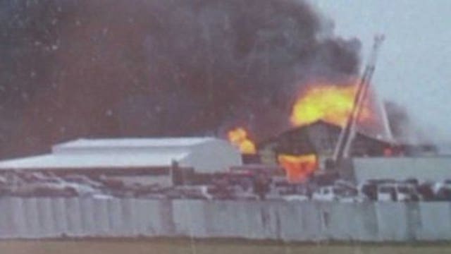 Roof collapses, dense smoke billows from 3-alarm fire at auto salvage yard