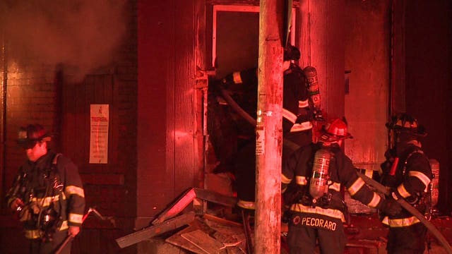 'Absolutely packed' with junk: Firefighters battle vacant building fire near 12th and Juneau