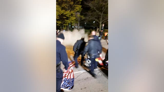 Protesters set American flag on fire, MPD officers ceremoniously fold it up