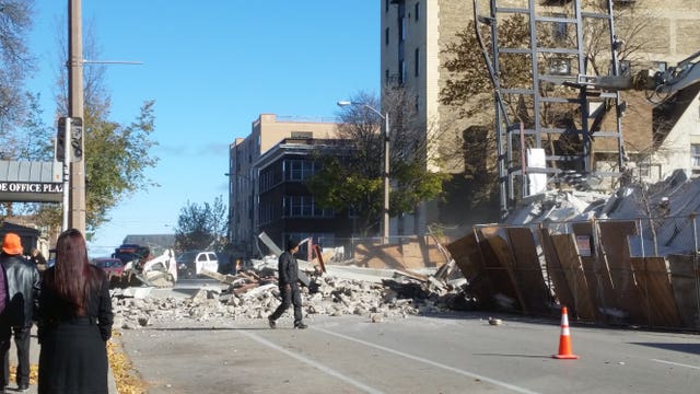 Building collapses during demolition, sending debris into street: "The whole building shook"