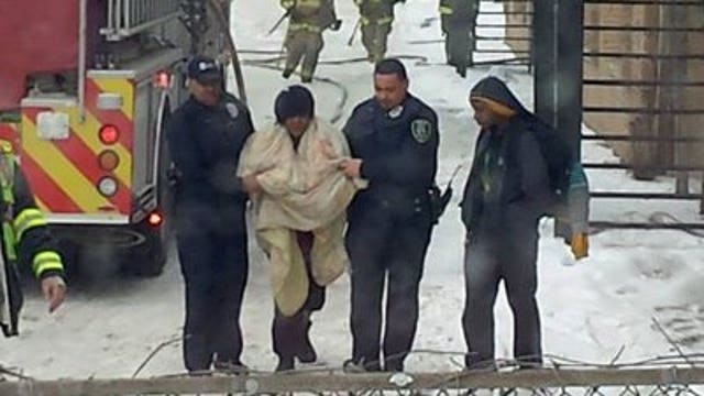 Police officers help rescue residents from burning apartment