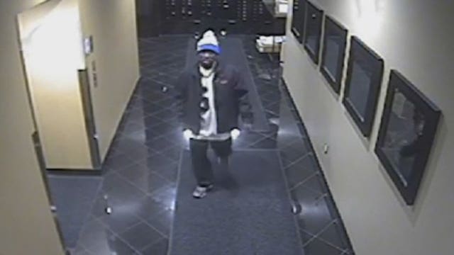 Caught on camera: Burglary suspect pries door, removes TV from apartment building