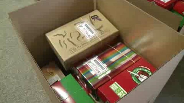 Volunteers filling shoe boxes for the holidays, to be sent around the world