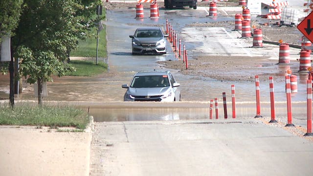 Driver stuck in standing water after water main break near Klement's off Chase Avenue