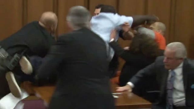 Father of victim leaps across table to grab serial killer's throat during sentencing hearing