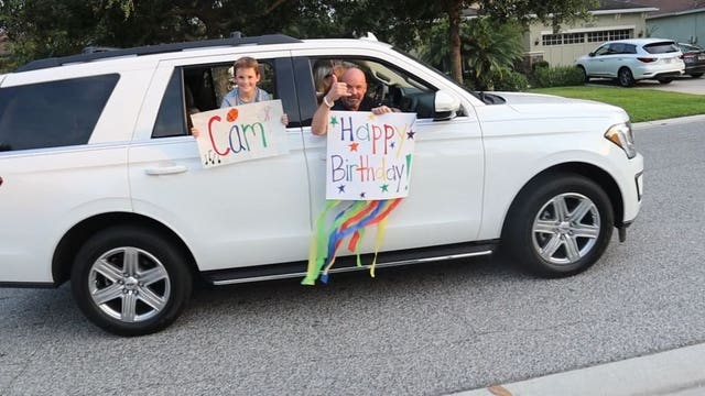 With a big smile on his face, boy's birthday becomes extra special with surprise drive-by parade