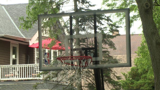 After basketball game with kids near 47th and Clarke, officers decided to buy them a new hoop