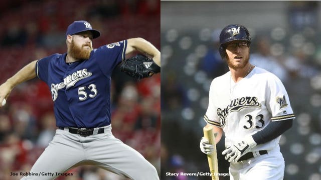Brewers option Phillips to minors to make room for Woodruff