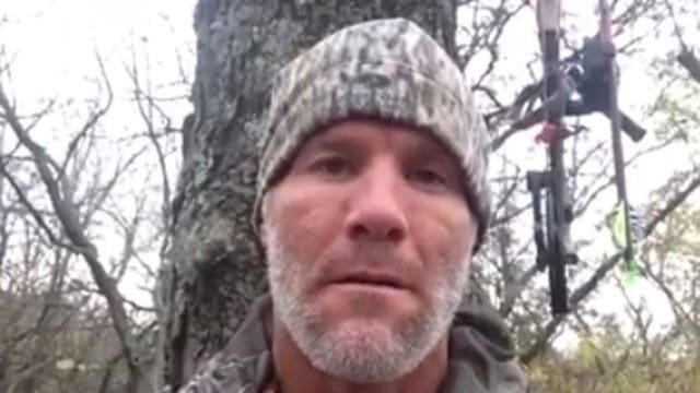 From a tree stand, Brett Favre congratulates Peyton Manning on passing record