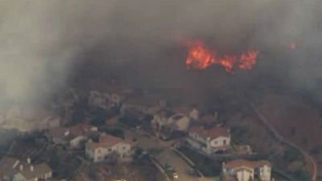 Roaring winds fuel raging Southern California wildfire