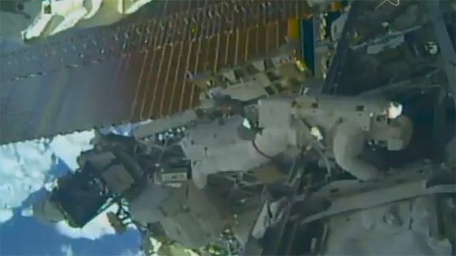 Spacewalking astronauts set up TV cameras for arriving ships