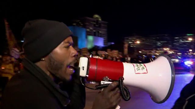 Estimated 1,200, including Dontre Hamilton's family, take part in protests during GOP debate
