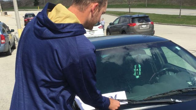 Brewers players, staff members hand out 2,500 "thank you" letters with free tickets for fans