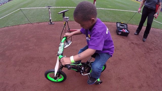 "Teamwork mentality:" Brewers help Milwaukee kids build their very first bikes