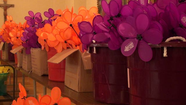 Volunteers craft symbolic flowers for annual Alzheimer's walk