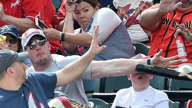 Hero fan saves boy from getting clobbered by flying bat at spring training game