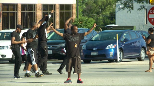 Protesters march in, near Mayfair Mall in Wauwatosa: "Standing up for injustice and inequality"