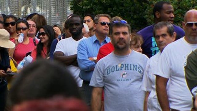Voters wait in long lines to cast ballots even before Election Day