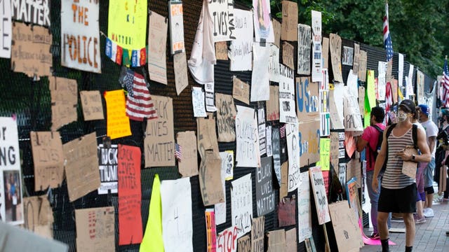 White House anti-riot fencing now covered with signs from protesters