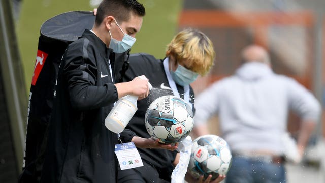 Fist bumps and masks: Professional soccer returns in Germany