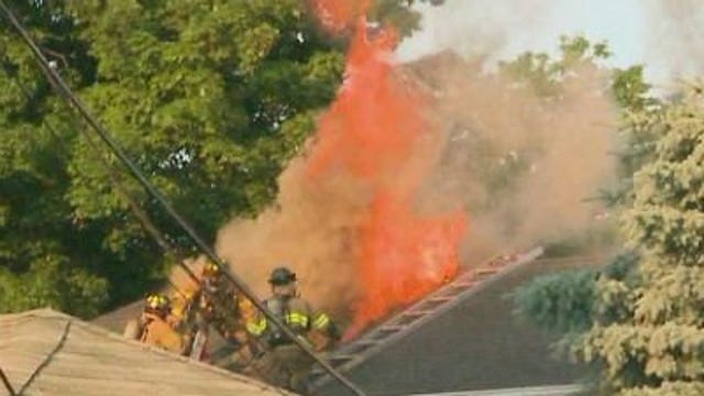 Fire destroys three garages, chars home & apartment building