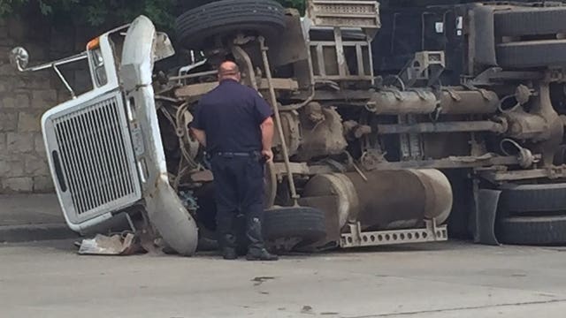 Driver cited after cargo in truck struck bridge near Locust & Fond du Lac, causing truck to tip