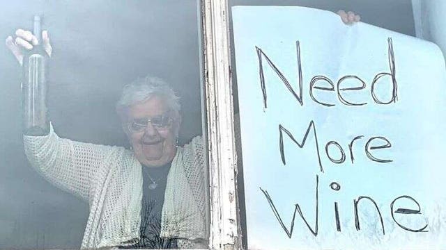 Quarantined Grandma with 'Need More Wine' sign goes viral