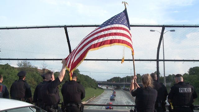 'It's the least I can do:' Crowds of people, law enforcement gather to overpass to watch procession for fallen officer