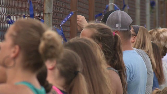 'We are here for her:' Ribbons tied to fence outside school where fallen officer's widow teaches