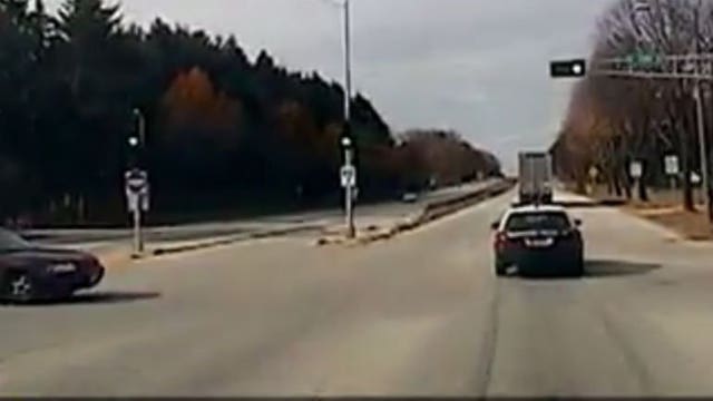 WHOA! Watch as driver runs a red light and slams into an MPD patrol wagon, injuring an officer